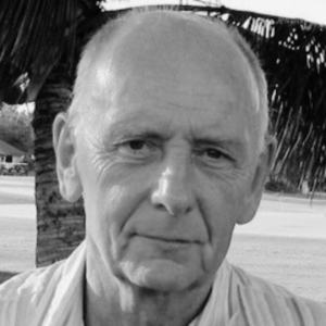 A black and white image of Michael Wemms infront of a palm tree