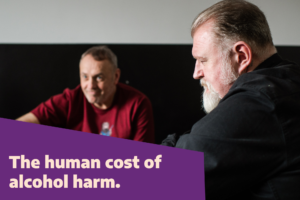Side profile of a man with a beard in a black shirt. Text overlay reads, "The human cost of alcohol harm."